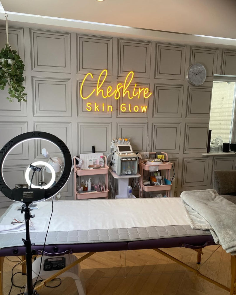 Cheshire Skin Glow LED neon brand sign glowing inside a modern beauty clinic