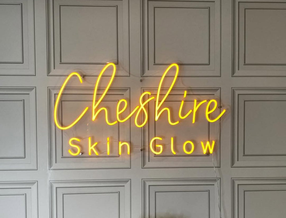 Warm Cheshire Skin Glow neon sign adding a gentle glow to a beauty treatment space