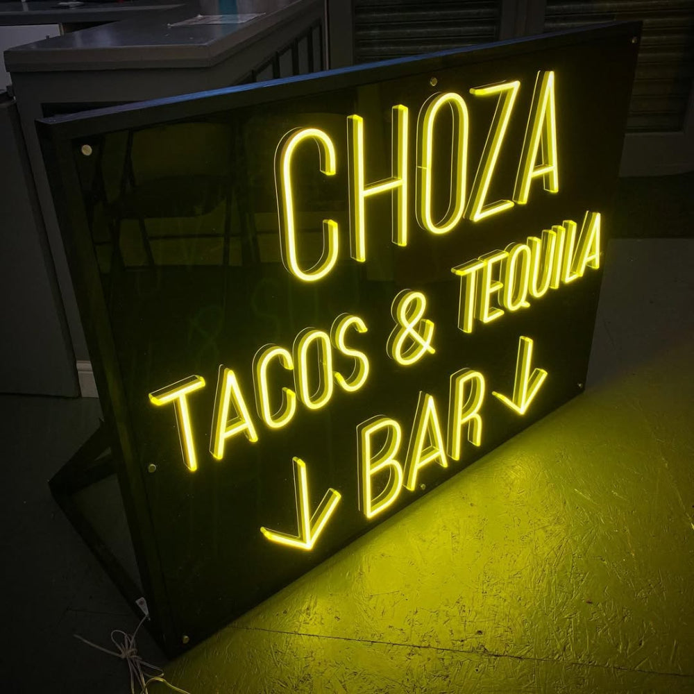 Choza Tacos Tequila Bar LED neon sign glowing in a Mexican-style restaurant
