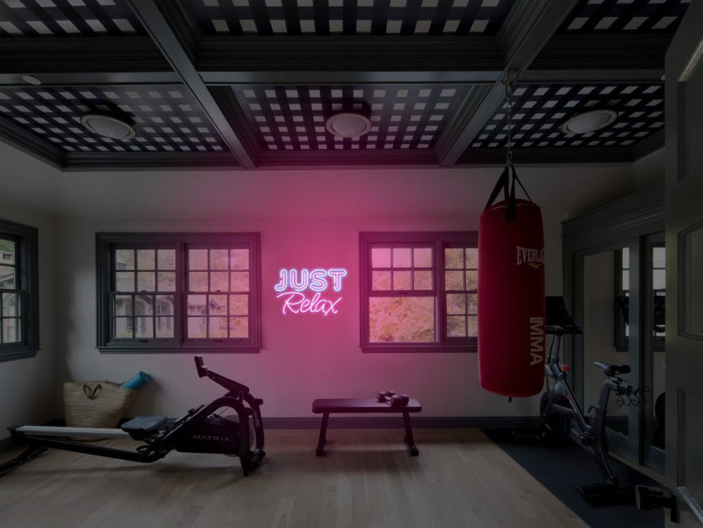 Just Relax LED neon sign mounted on the wall of a boxing and fitness gym