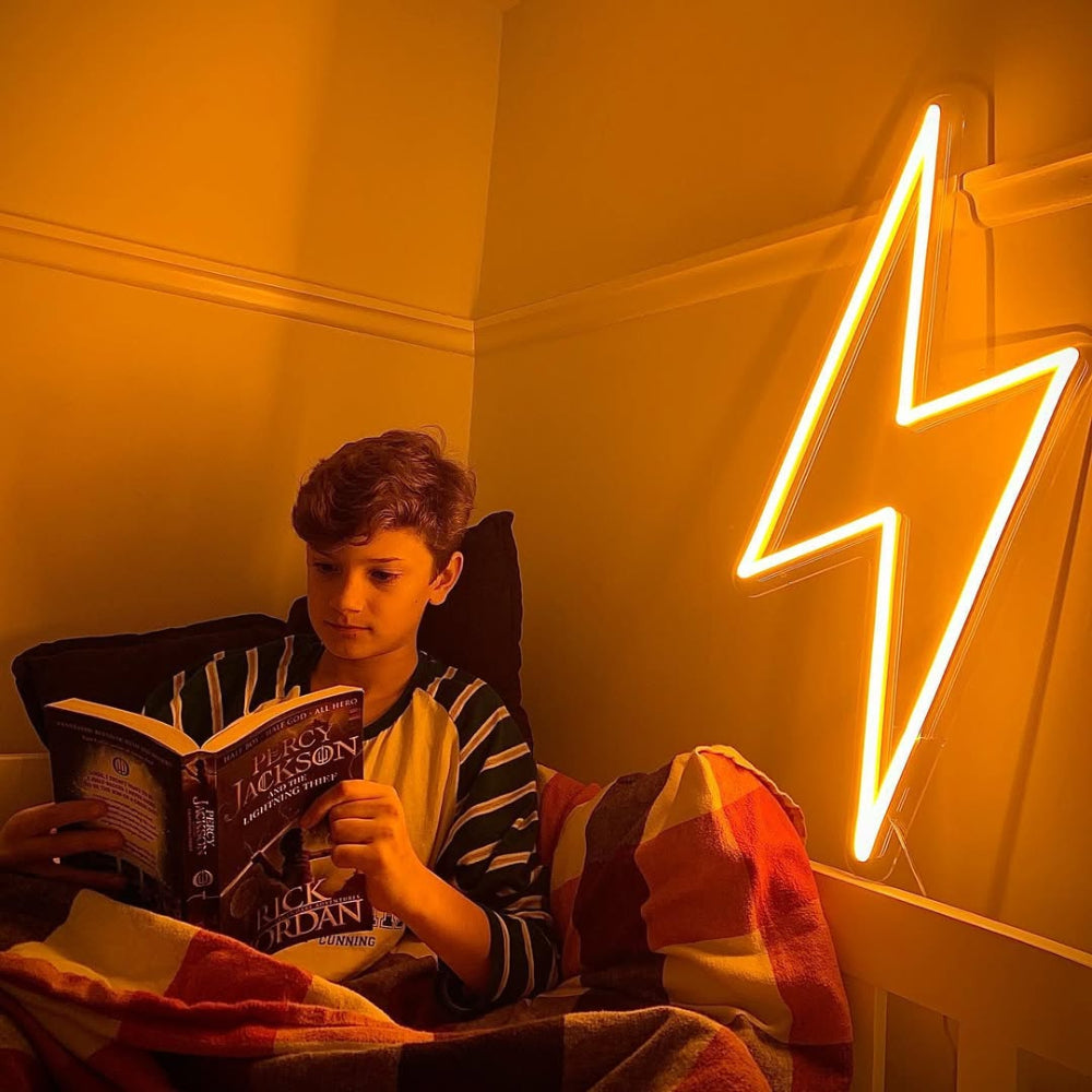 Bright lightning bolt LED neon sign glowing on the wall of a child’s room