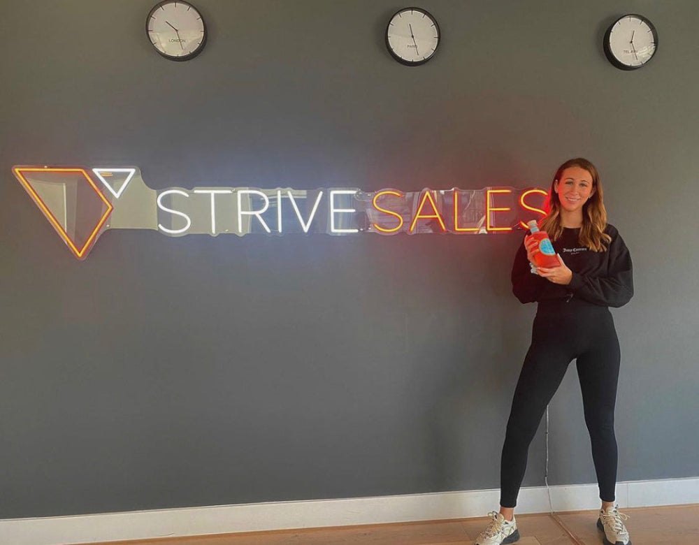 StriveSales custom neon brand logo sign used as office décor and branding
